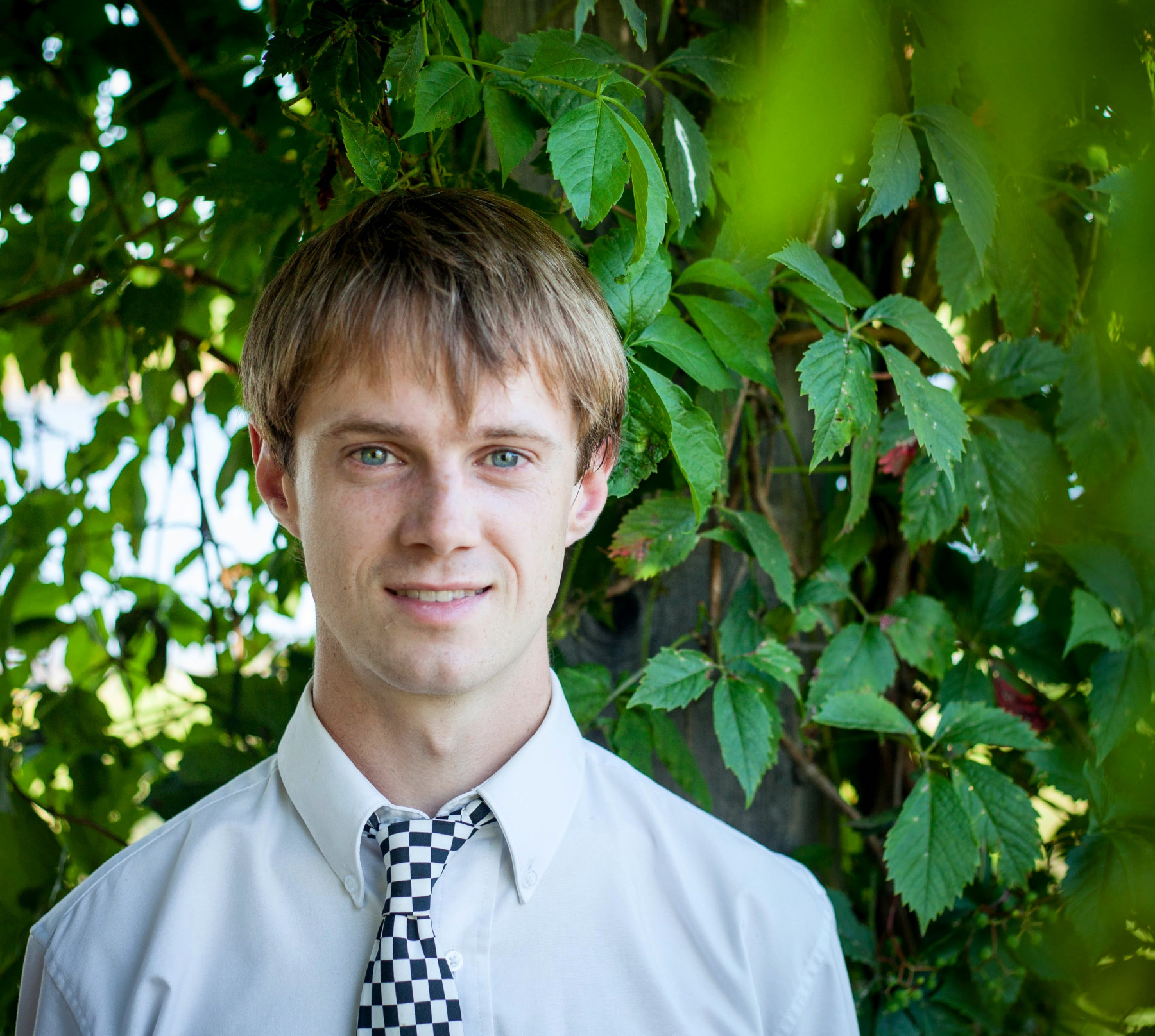 Mark in a garden wearing a crooked tie